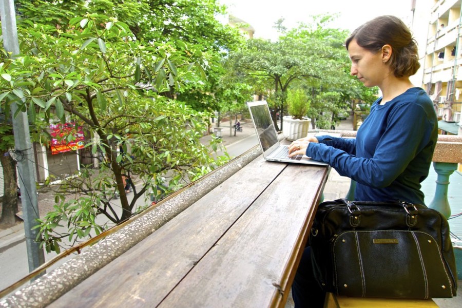 Michelle working on laptop outside in Hanoi Vietnam