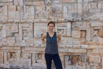 author in front of stone wall