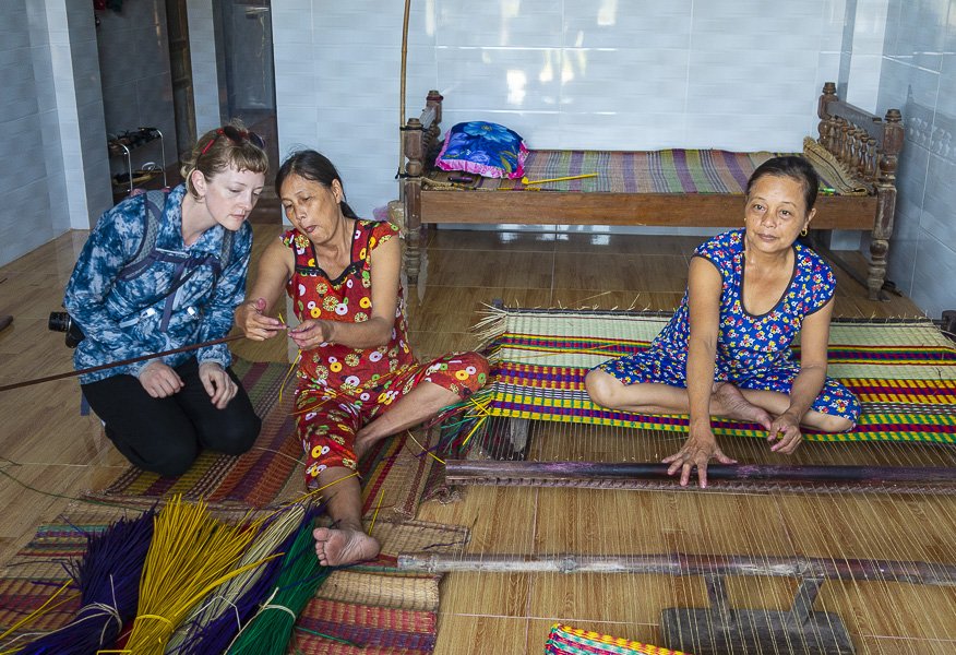 Ladies of the sleeping mat village shows how to weave mats