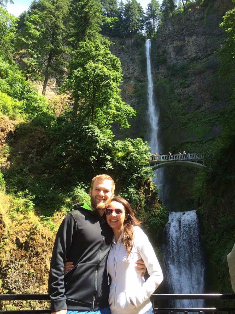 couple in front of Multnomah Falls