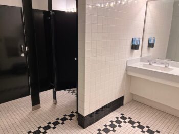 white tile bathroom stall and sink