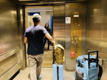 Jedd inside elevator with luggage