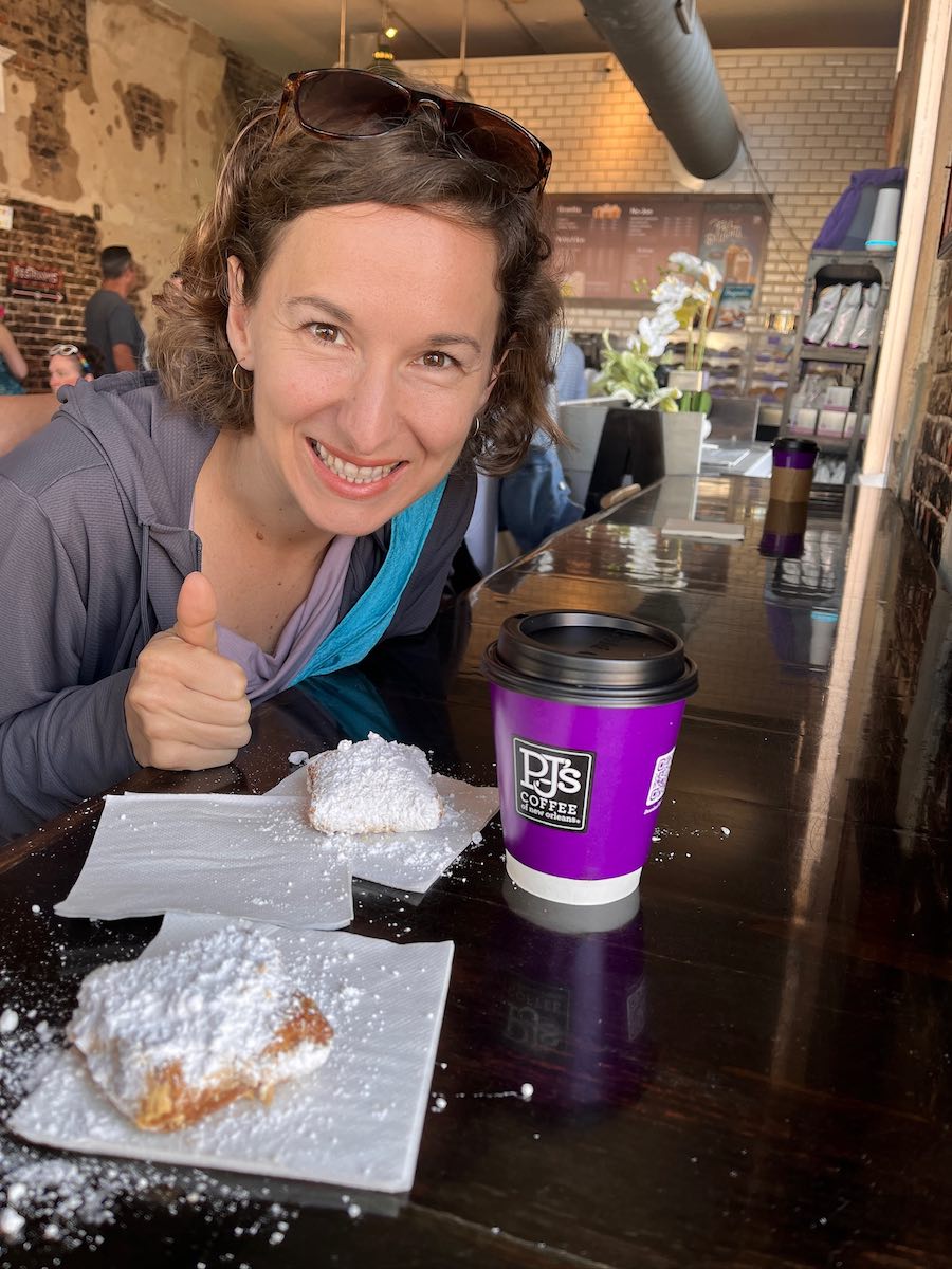 Michelle with powdered sugar-topped beignets and coffee at PJs