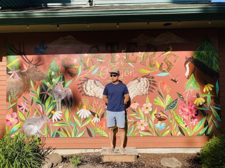 Jedd in front of instagrammable mural in sisters oregon