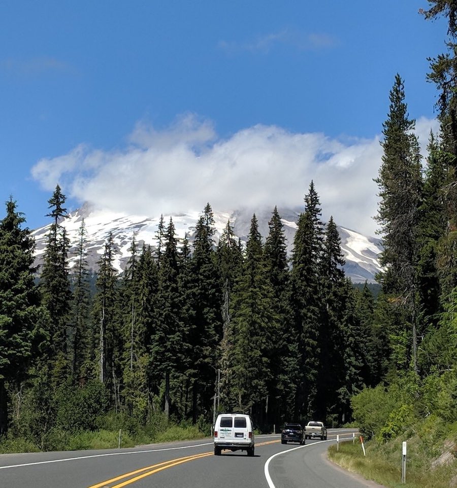 Drive to Central Oregon - car on the road with tress and sky background