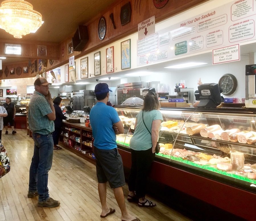 people ordering at deli counter