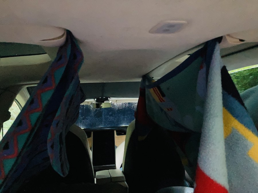 blankets hung from ceiling of Tesla